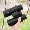 Hiker holding good binoculars for outdoor recreation