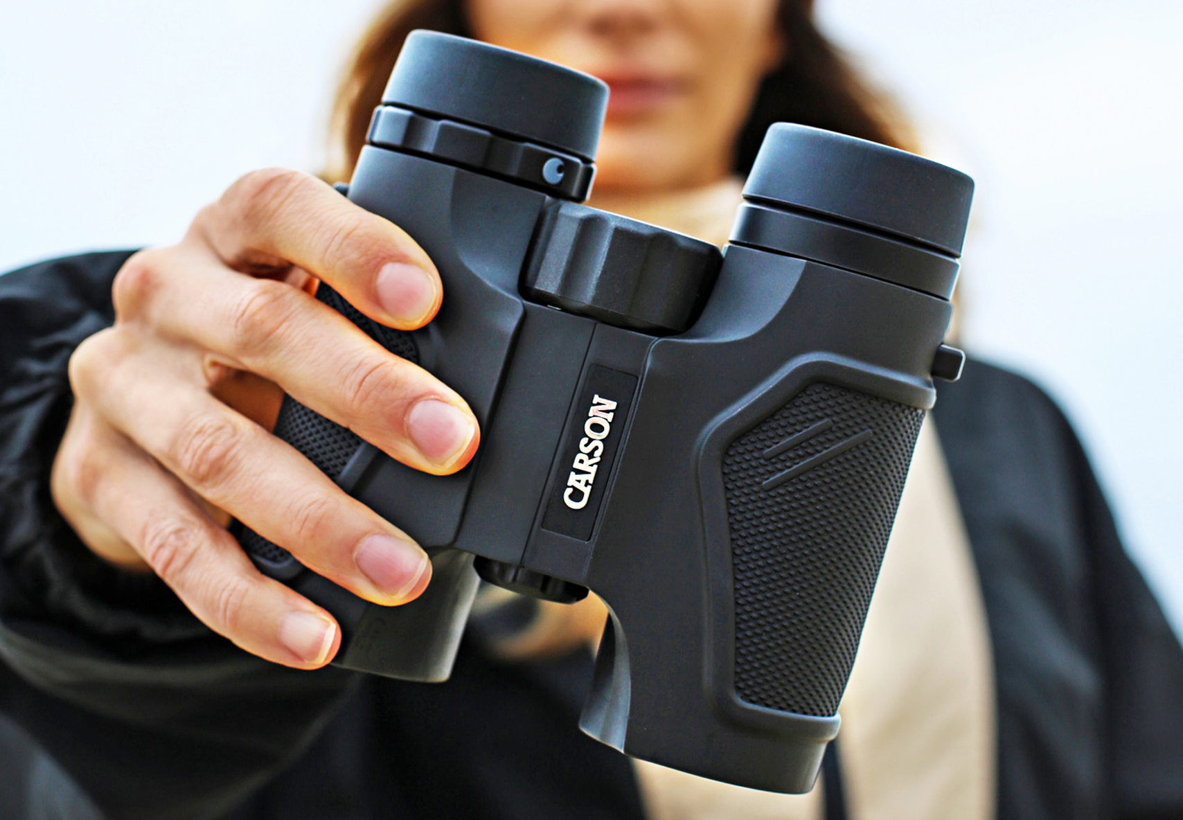Closeup image of woman holding binoculars