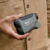 Hunter in wildlife environment holding Carson LiteWave Pro Golf Rangefinder for convenience in nature adventure and clear image and vision