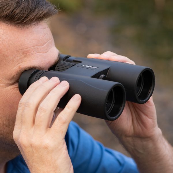 camper using carson binoculars for bird watching on outdoor adventures, rubber binocular eyecups for glasses with binoculars